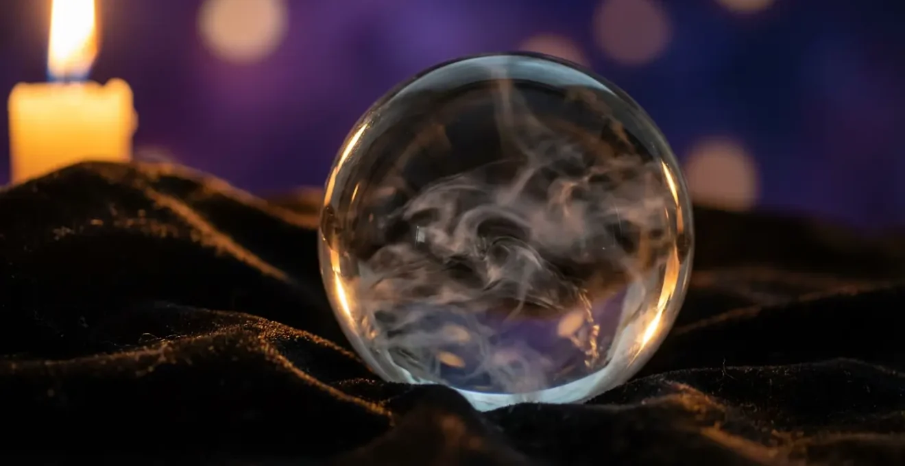 Bola de cristal transparente con reflejos de humo interior en ambiente de meditación