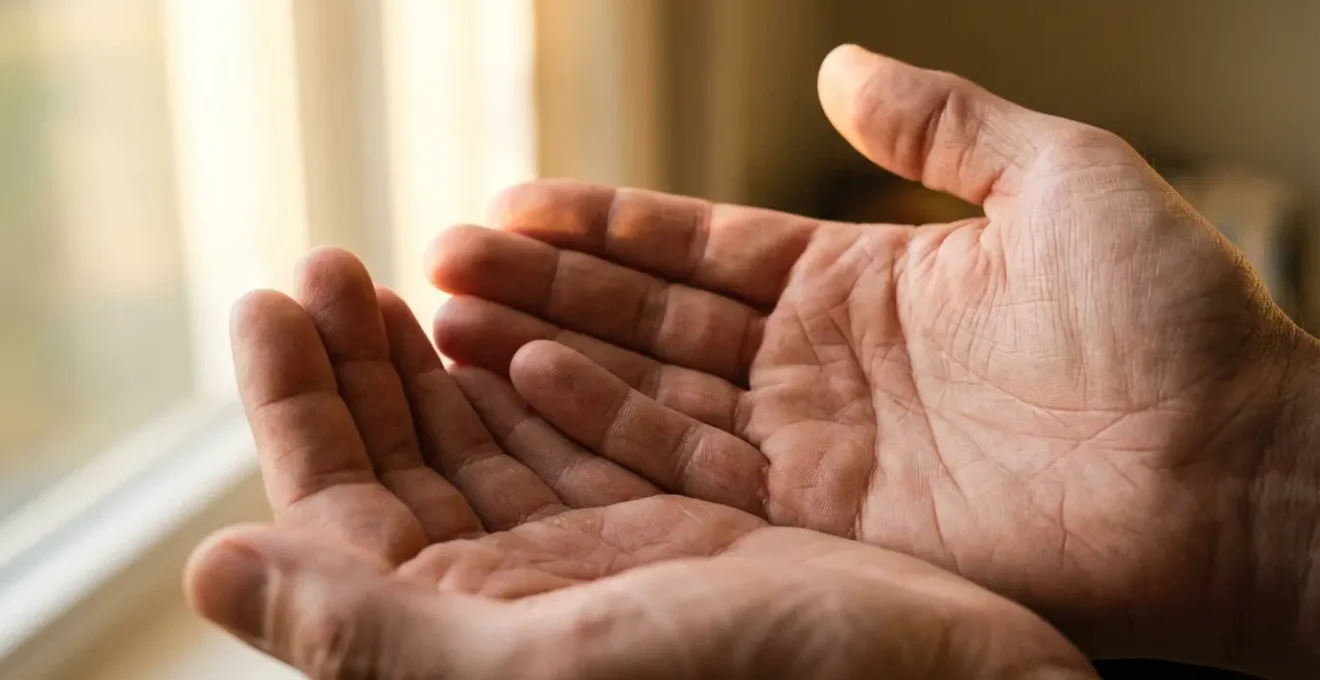 Palmas de manos extendidas mostrando líneas naturales y cambios sutiles en la luz dorada